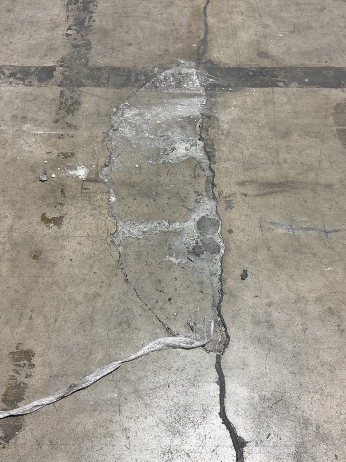 Spalled, broken concrete where two joints cross