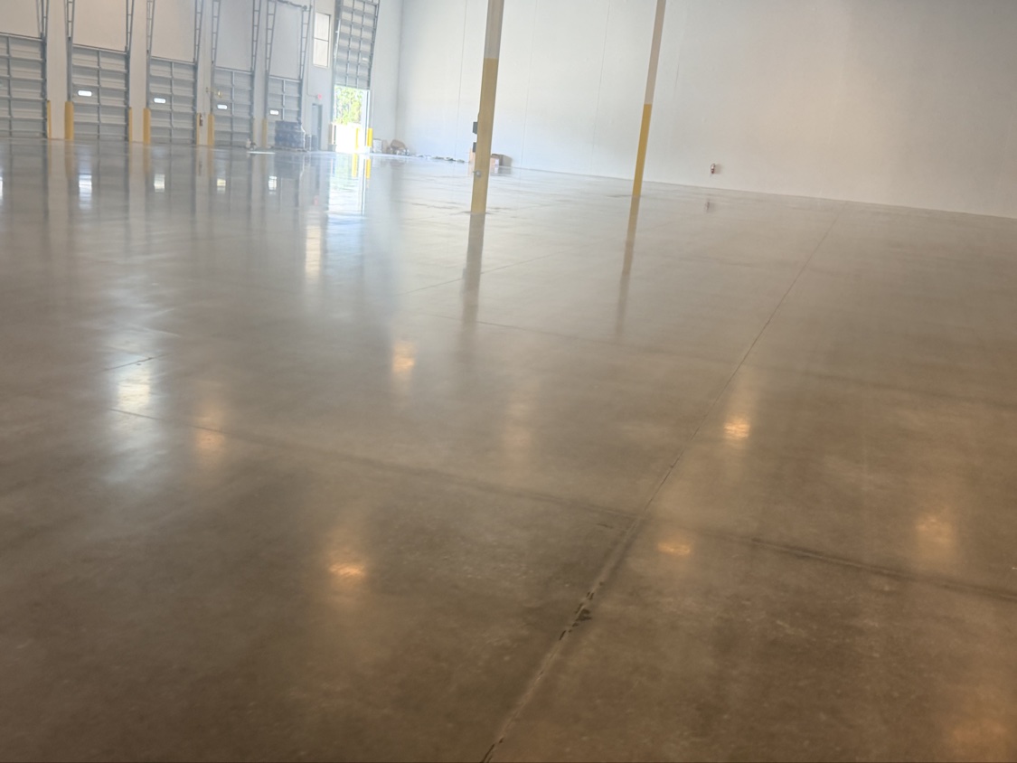 Glossy finished warehouse floor in front of a row of dock doors
