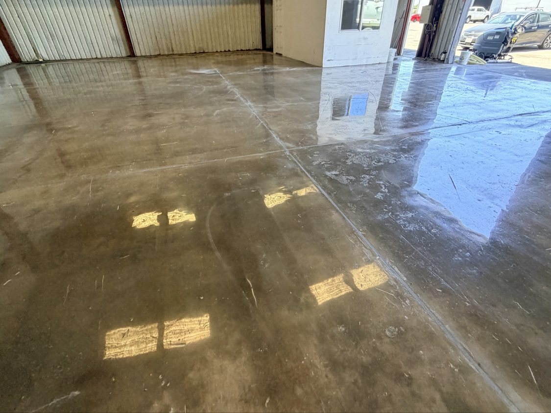 Glossy finished concrete floor inside a metal building