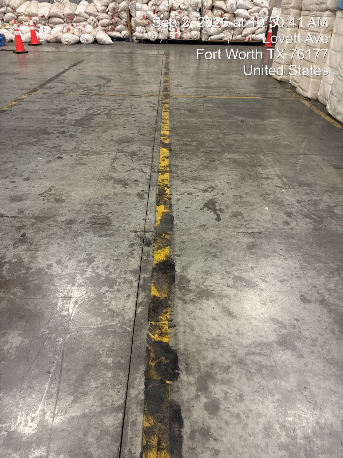 Lovett Ave aisle in Fort Worth with a worn traffic line and stained concrete