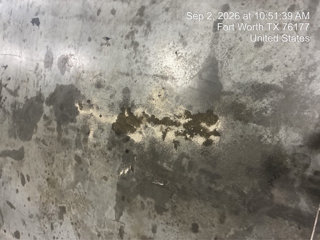 Stained, worn existing slab documented at the Fort Worth facility