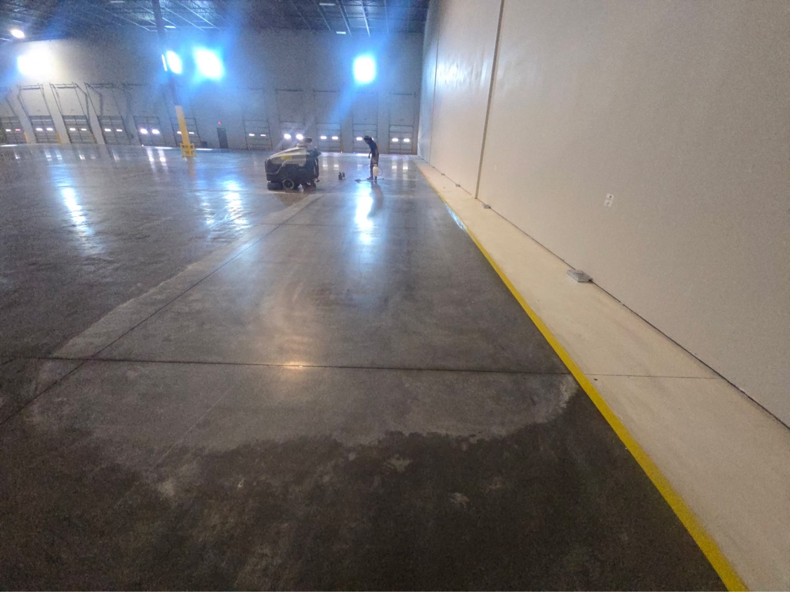 Crew putting the final pass on a glossy treated warehouse floor
