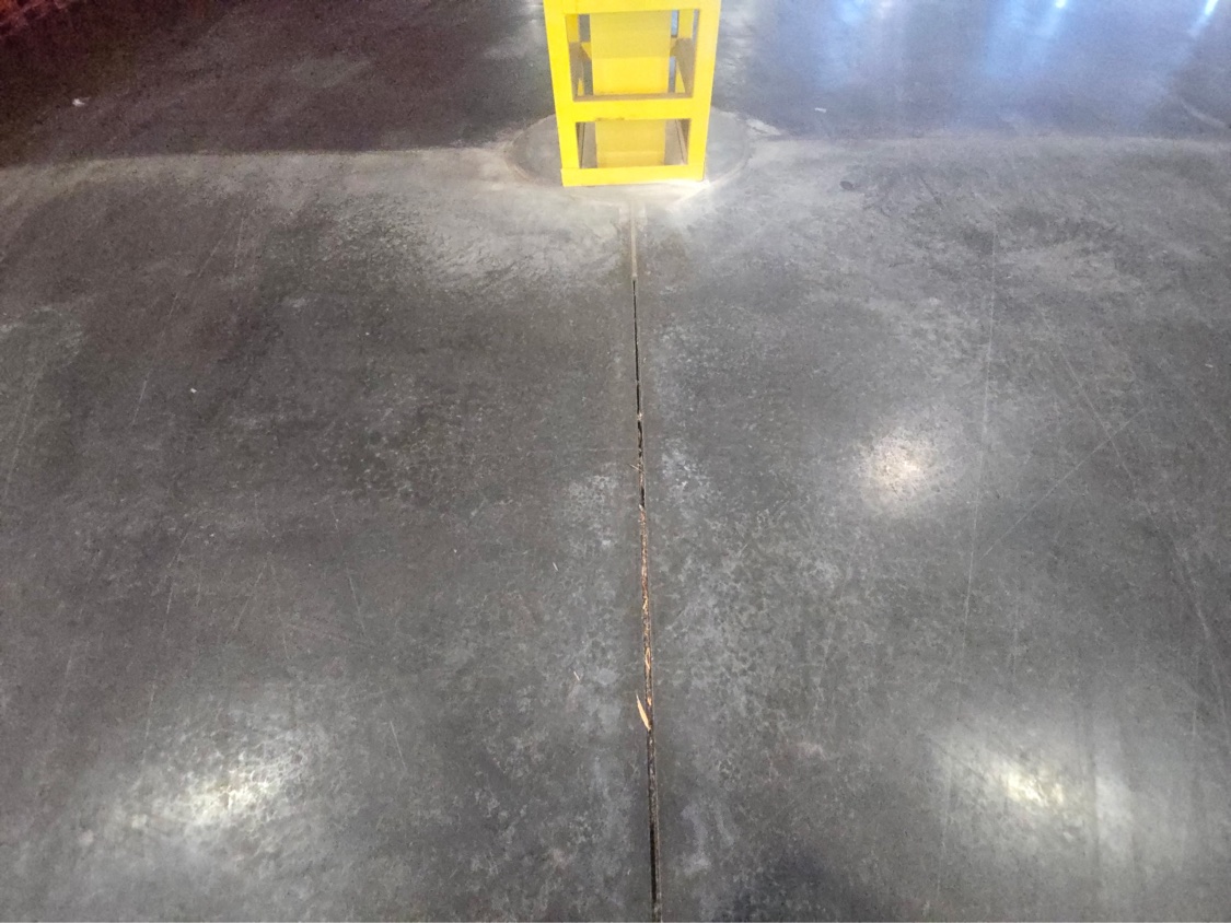 Open, failed control joint running past a warehouse column before joint fill repair